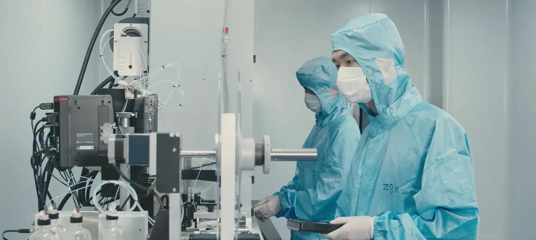 A technician working to standard in a controlled laboratory environment