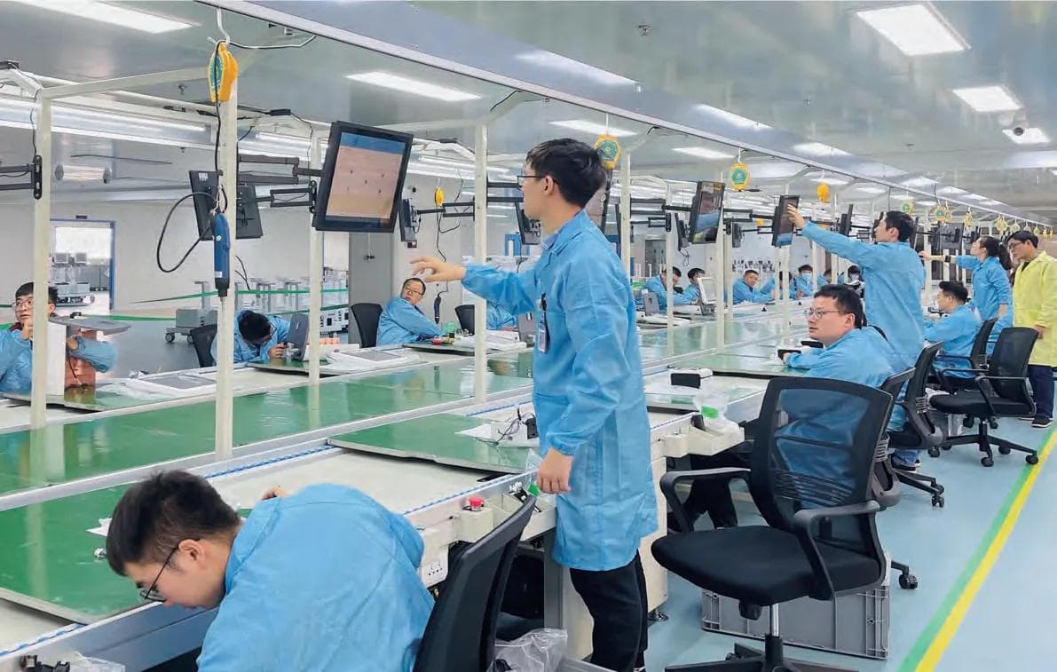 Two technicians working together at an instrument line